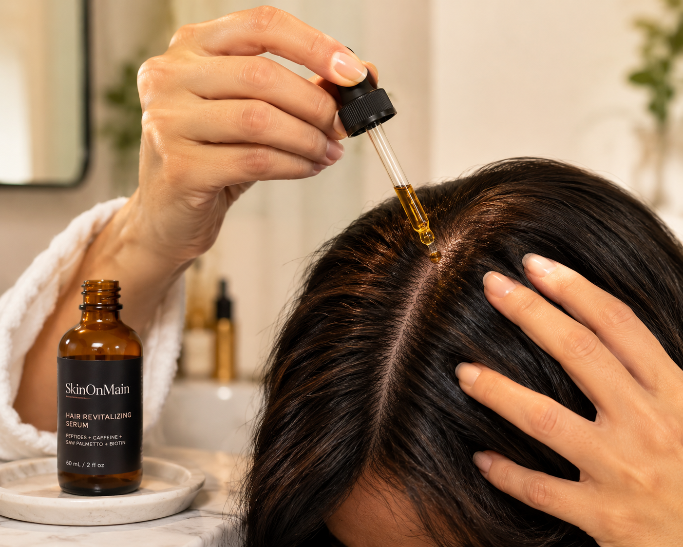 Applying a SkinOnMain hair revitalizing serum to the scalp